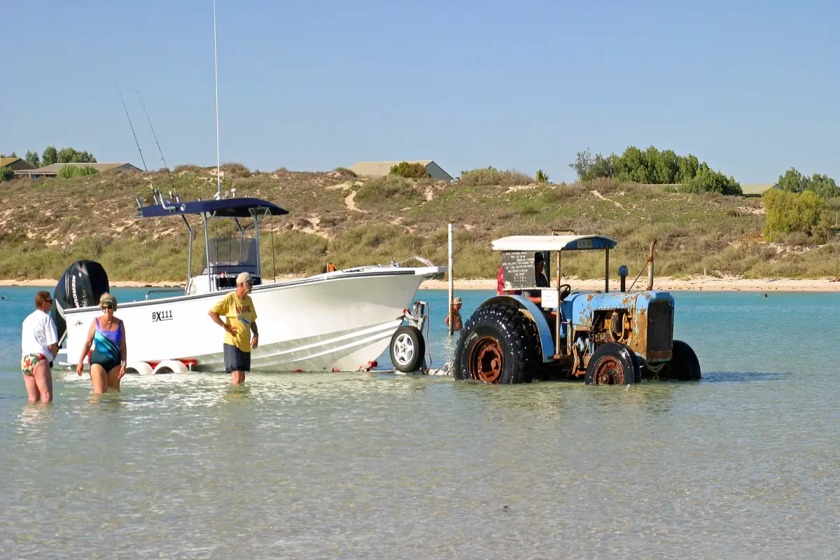 A tractor launching a boat into the bay at Coral Bay