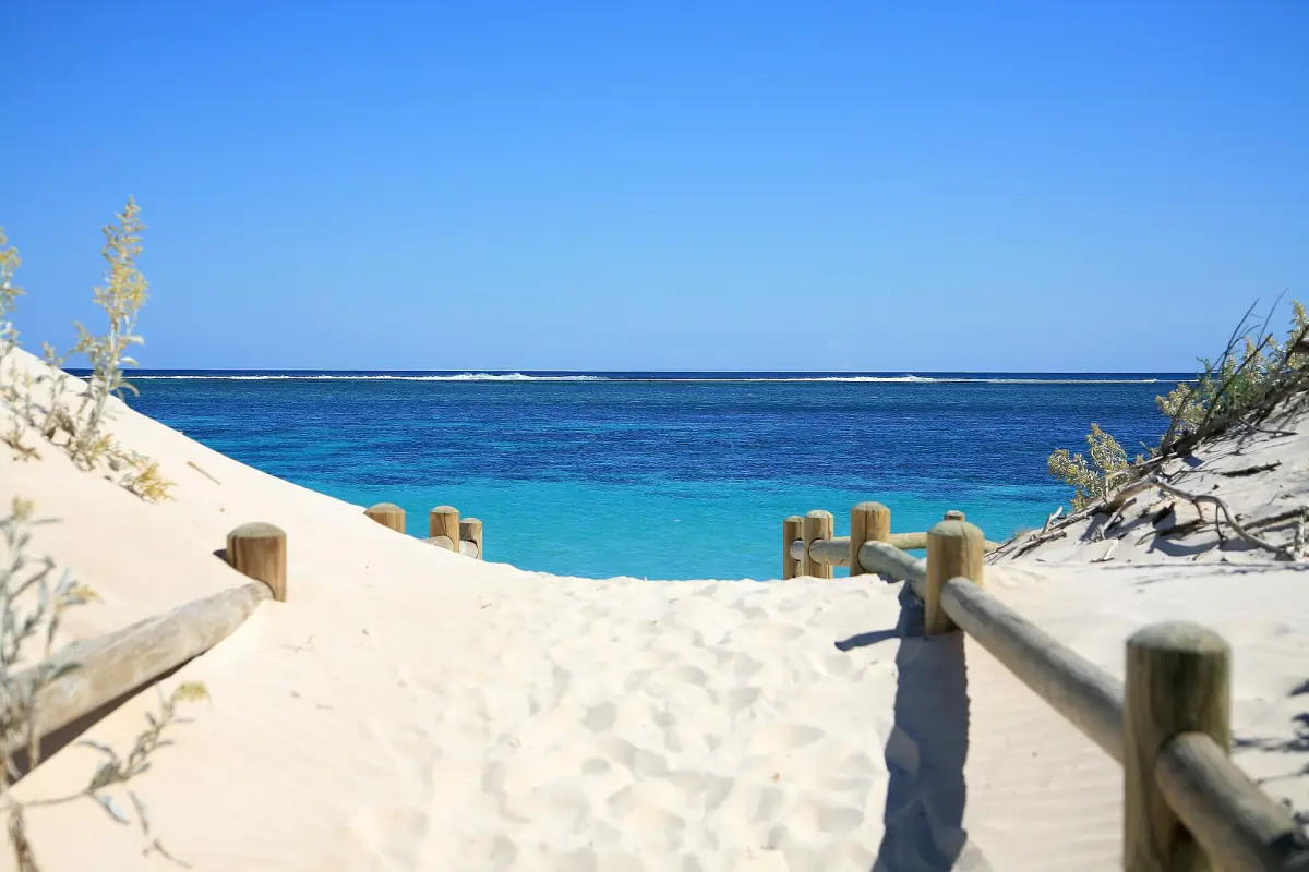 A boardwalk over the dunes to a turquoise Ningaloo beach